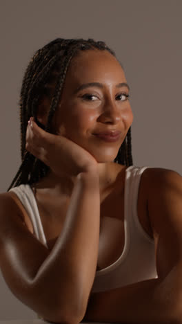 Studio-Beauty-Shot-Of-Young-Woman-With-Long-Braided-Hair-Sitting-At-Table-7